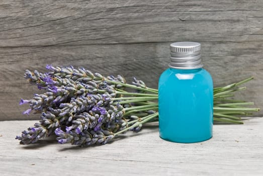 Lavender and some hygiene items made of lavender on an old wooden shelf.