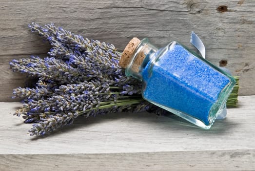 Lavender and some hygiene items made of lavender on an old wooden shelf.