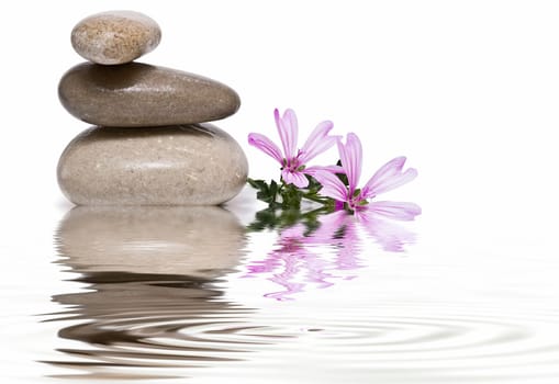 Boulders in zen balance over a white background.