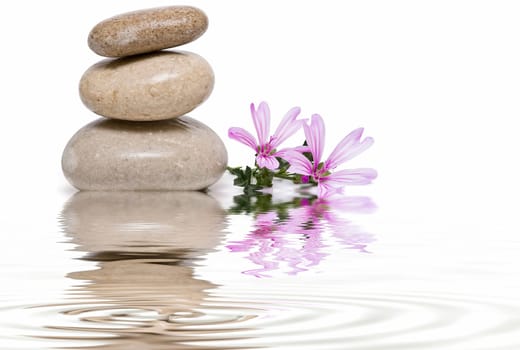 Boulders in zen balance over a white background.