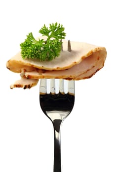 Roast pork with parsley on a fork