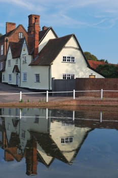Cottages reflected on village pond