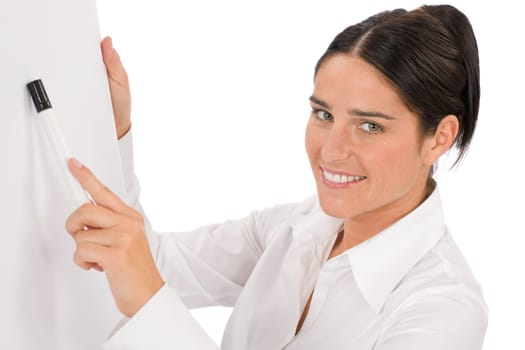 Happy businesswoman pointing at empty flip chart on white
