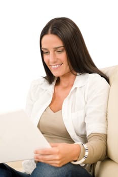 Attractive woman with laptop sitting on couch smiling