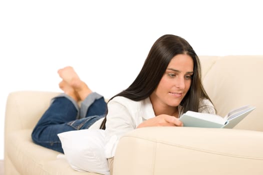 Attractive mid-aged woman read book on sofa in lounge