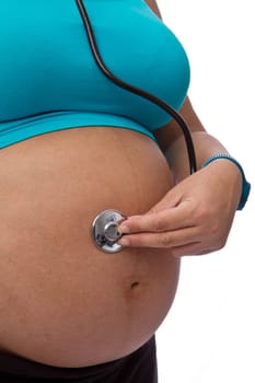 young pregnant woman listening stethoscope of his future child