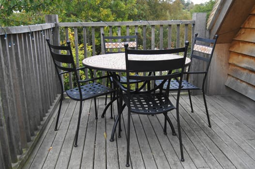 Table and Chairs on a Balcony in the trees