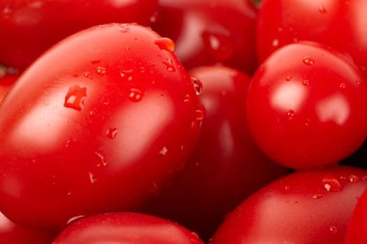 Red tomatoes with water drops in close-up.