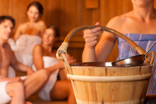 Four friends in the sauna of a thermal bath