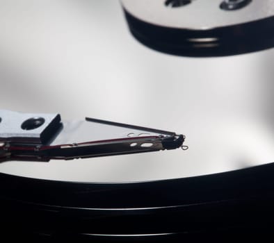 Magnetic disc inside a computer hd unit showing mirror surface of the magnetic discs and read write head
