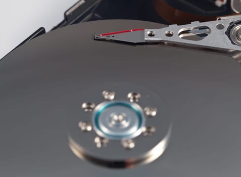 Magnetic disc inside a computer hd unit showing mirror surface of the magnetic discs and read write head