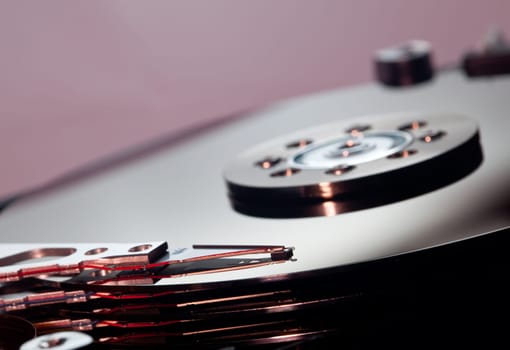 Magnetic disc inside a computer hd unit showing mirror surface of the magnetic discs and read write head