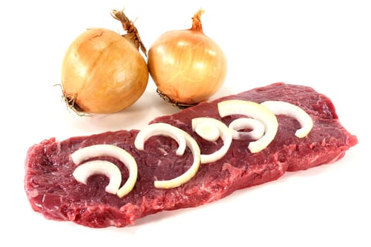 a fresh,raw rump steak against a white background