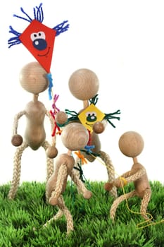 a family of wooden dolls fly kites