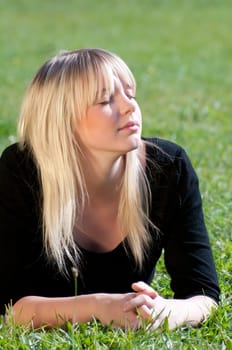 Young woman lying on a meadow