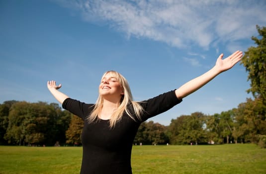 Young woman spreads her arms