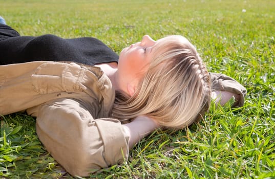 Young woman lying on a meadow