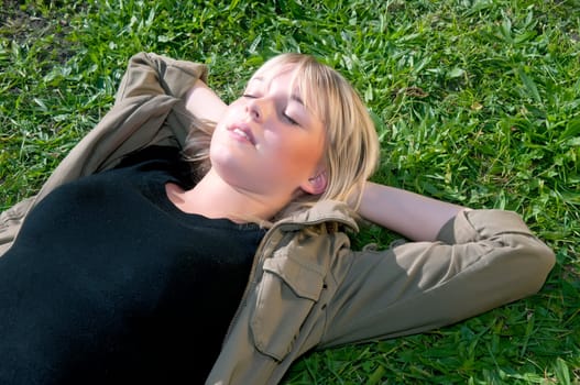 Young woman lying on a meadow