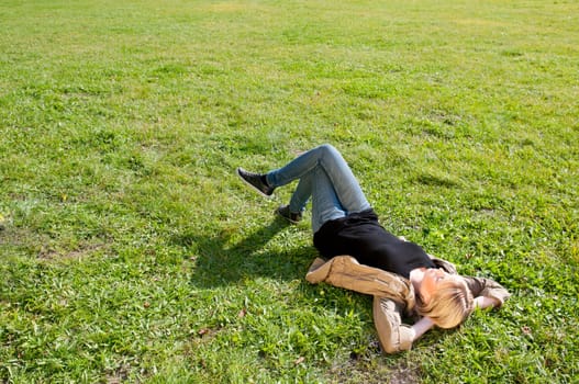 Young woman lying on a meadow