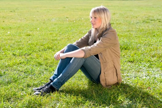 Young woman sitting on a meadow