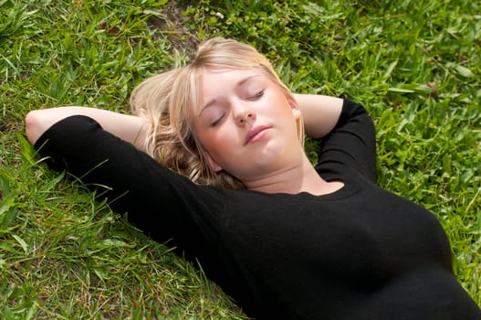 Young woman lying on a meadow