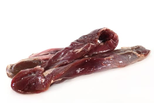 two lamb fillets against a white background