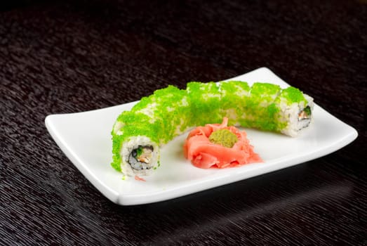 Sushi rolls made of salmon, avocado, flying fish roe - tobiko caviar and philadelphia cheese