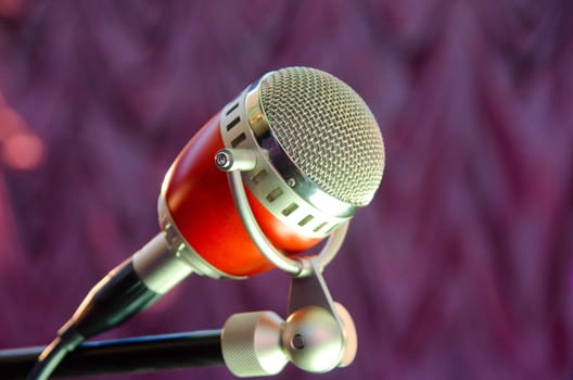 Closeup of audio microphone on stage background