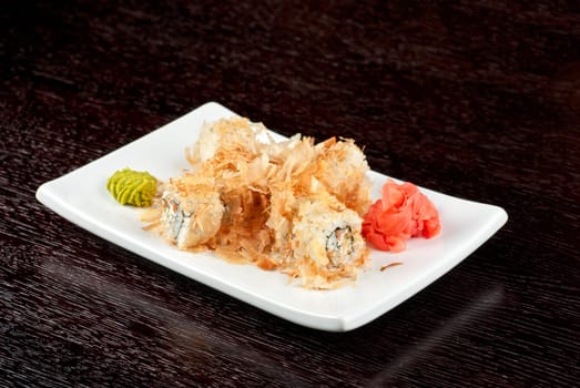 Sushi rolls of rice, nori, cream cheese, avocado, smoked salmon,cucumber and cuts of tuna