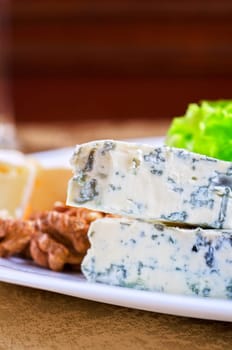 cheese with lettuce, grapes and nuts closeup