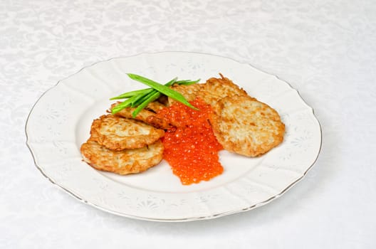 pancakes with red caviar and green onion closeup dish