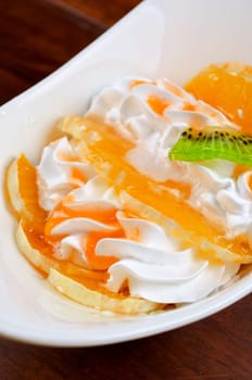 Ice cream dessert with kiwi, strawberry and orange