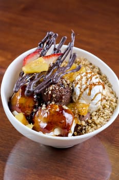 ice cream with chocolate, nuts and caramel close up
