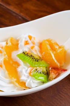 Ice cream dessert with kiwi, strawberry and orange