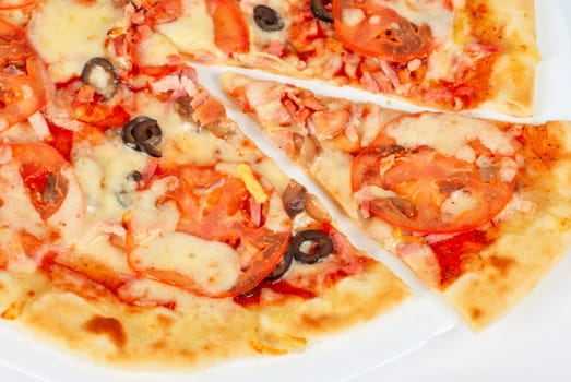 meat pizza closeup with carbonado ham, tomato, olive and mozzarella cheese