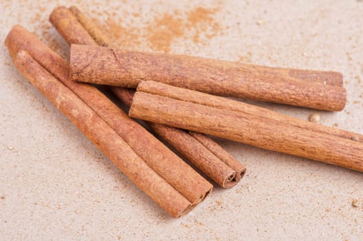 Cinnamon stick closeup on a brown background