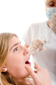 Young girl at the dentist scared of the injection