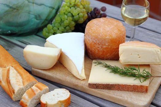 Cheese platter with wine,grapes and baguette