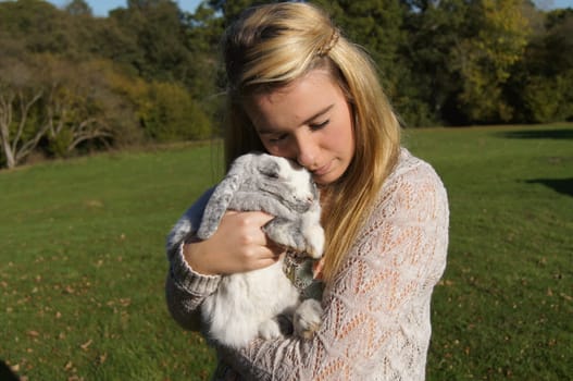 Girl Cuddling Her Pet Rabbit