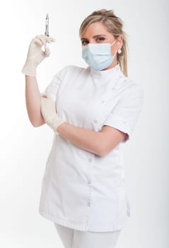 Attractive blonde female health worker holding a syringe