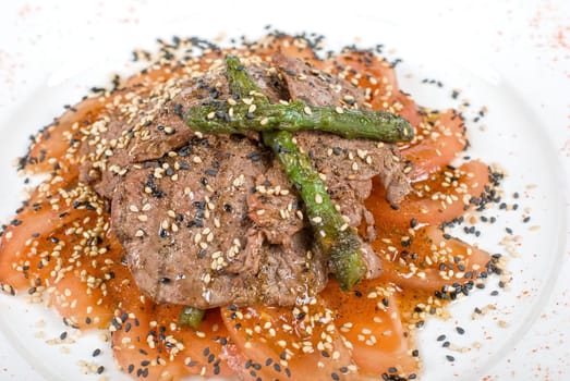 Salad from beef closeup with white mushrooms, string beans, asparagus, spinach, and tomatoes carpaccio
