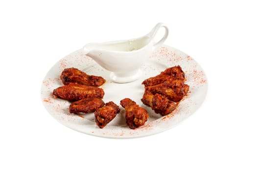 chicken wings with sauce at white plate