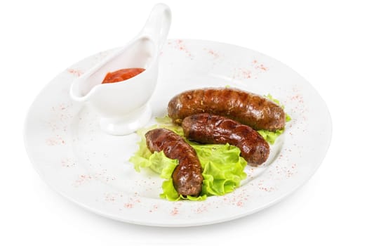 grilled venison sausage on a white with lettuce and sauce