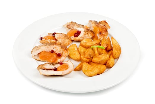 Roast chicken meat with apricot and potato closeup