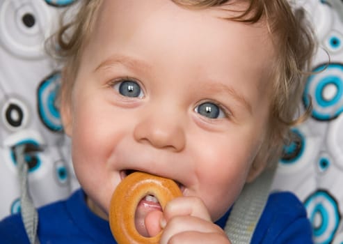 pretty baby boy laughing portrait with bread ring