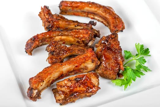 roast rib pork with parsley on a white plate