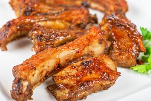 roast rib pork with parsley on a white plate