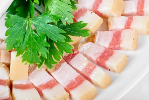 Sliced pig lard with greens closeup