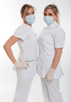 Two female healthcare workers with masks face to face