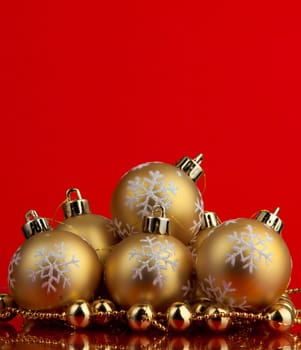 golden christmas balls of red background